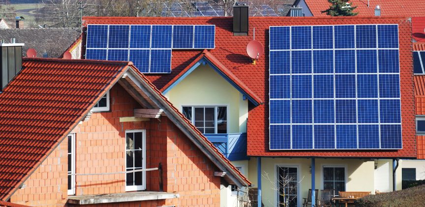 Houses with solar panels installed on the roof.