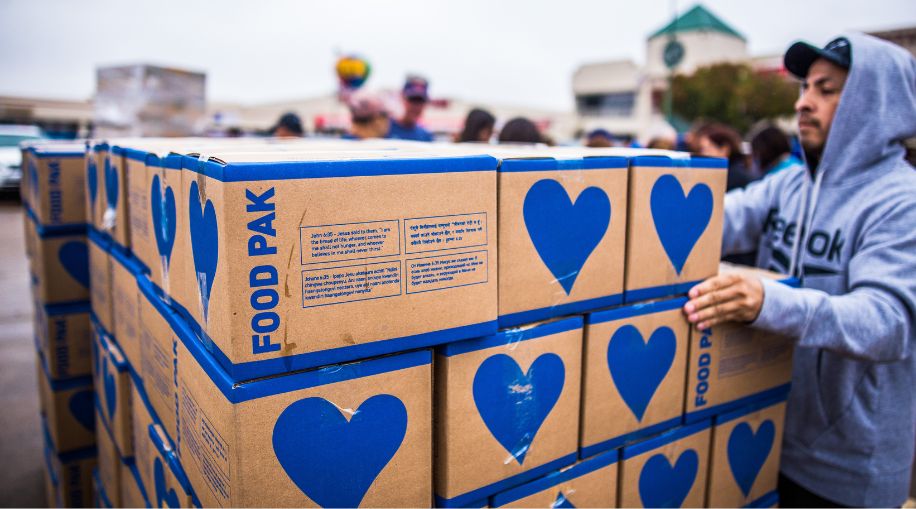A man sorting boxes of food bank donations.